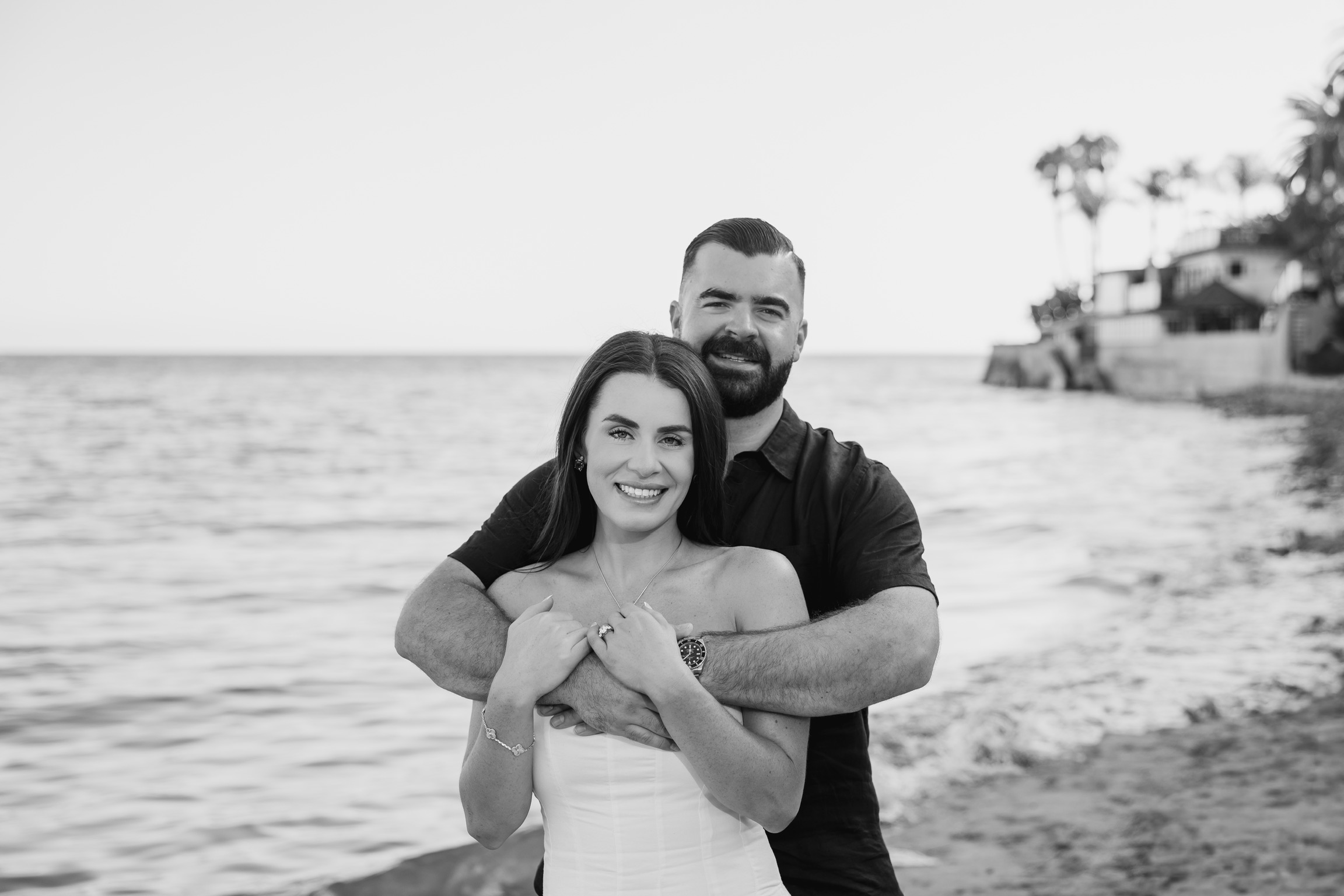 Belinda and Nicholas embracing on the beach